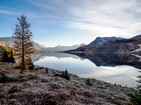 Hiking from Ptarmigan Lake to Packers Pass. Calm morning scenery over Ptarmigan Lake.