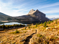 Hiking from Ptarmigan Lake to Packers Pass. Calm morning scenery over Ptarmigan Lake.