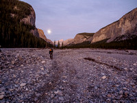 Biking up a surreal landscape along the Ghost River with a very bright moon providing any light we might still need