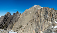 A very distinctive wall of bubbled rock at right. False summit visible.