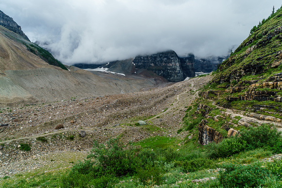 Low cloud hides the big peaks as we approach the cool ledge traverse on the main trail to the Plain of Six Glaciers tea house.