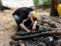 Eric is a rookie canoeist so he lights the fire and gathers the wood.