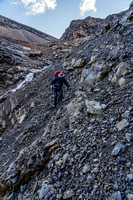 Traversing steep rubble slopes to exit the headwall.