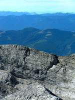 Jon descending off the summit ridge of Mount Tecumseh with Phillipps Peak in the background.