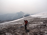 Phil crosses the glacier with Conical trying its best to show up through the choking smoke.