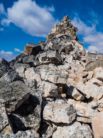 The west aspect of the summit block offers the easiest and safest terrain - but note the huge, loose boulders still balanced here.