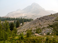 Phil plods up the steep grind to Boulder Pass - Ptarmigan Peak obscured by smoke in the background.