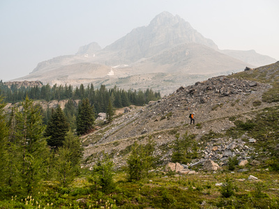 Phil plods up the steep grind to Boulder Pass - Ptarmigan Peak obscured by smoke in the background.
