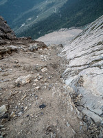 Riding the line between scree and slab, looking down my ascent.