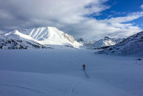Mike starts breaking trail on Ptarmigan Lake. Packer's Pass Peak and Fossil on the left.