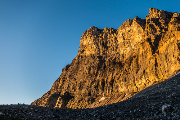 Warm sunrise on the cliffs above the approach traverse.