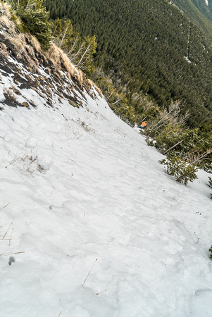 Lisa wisely puts her micro-spikes on for the slick east face slopes of Monad.