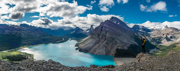Kaycie stands on the south end of the ridge above the low cliffs with a grand view over Bow Lake.