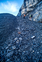 Grinding up the scree pile above the lower cliffs.