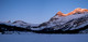 Crossing Bow Lake with sunrise on Portal and Thompson Peak at right. St. Nicholas and The Onion at left still in shadow.