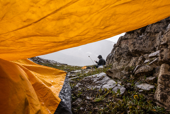 The view from under my tarp. Eric is sitting in the rain rather than get cooped up in his bivy sack already.
