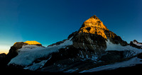 Mount Assiniboine with the moon as the sun sets. Our route goes up the ridge trending to skyline left from bottom left.