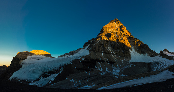 Mount Assiniboine with the moon as the sun sets. Our route goes up the ridge trending to skyline left from bottom left.