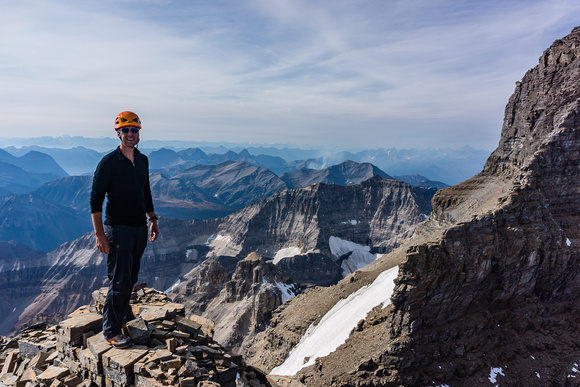 Vern on the summit of Lunette Peak. Assiniboine's SW face and east face to the right.