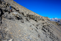 The scree slope / crumbly cliff bands above the amphitheater just below the upper mountain.