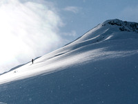 TJ breaks trail up the ridge to the first summit of Burstall Pass Peak.