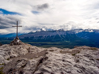 A dramatic summit view. Pyramid Mountain is the white one just to the right of the cross.