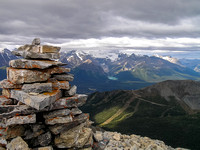 Summit cairn with Lake Louise and Mount Victoria in the bg.