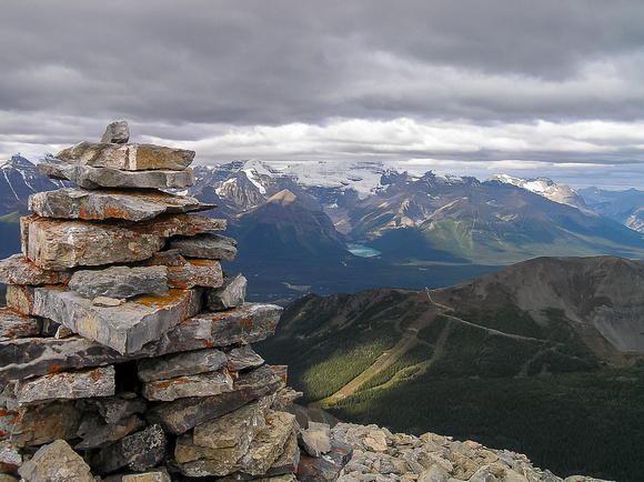 Summit cairn with Lake Louise and Mount Victoria in the bg.