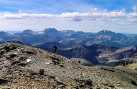 Jon comes up to the summit with Peabody (L), Kinnerly, Kintla, Long Knife and Akamina Ridge in the distance.