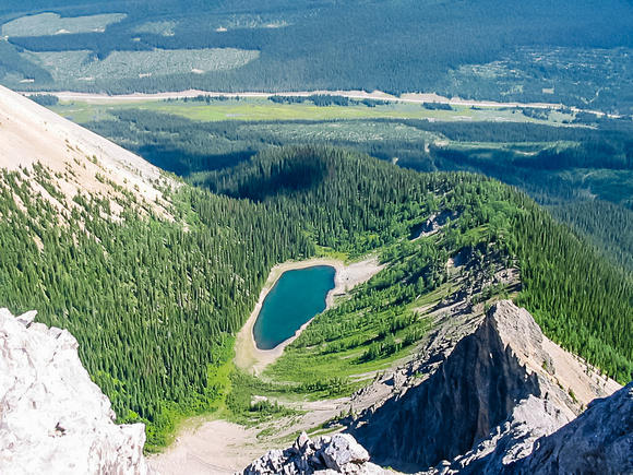 Gorgeous Tryst Lake with the Spray Lakes road in the background from the summit ridge of The Fist.