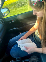 Friday is a long day of driving - KC reads her book.