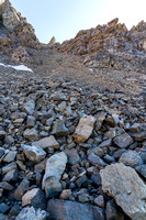 Ascending scree and boulders up north slopes of the Quartzite Col.
