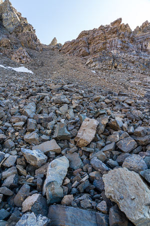 Ascending scree and boulders up north slopes of the Quartzite Col.