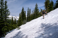 Traversing on snow slopes around the south aspect of the first false summit.