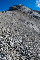 A highway in the scree leads folks directly to 4th class slabs under the summit. Go right instead...