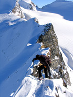 JW carefully down climbs the crux from the summit of St. Nicholas.